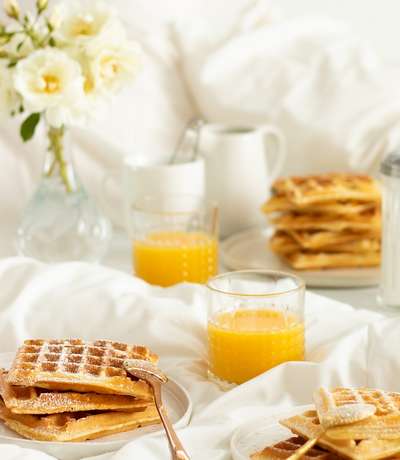 waffles and orange juice breakfast in bed