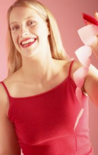 woman holding a garland of paper hearts