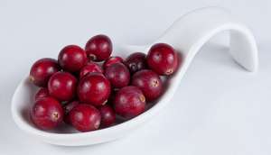 cranberries in a white spoon