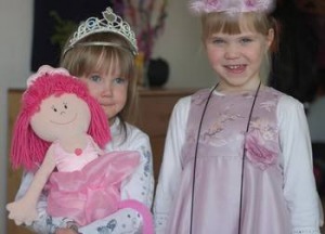 two girls wearing tiaras