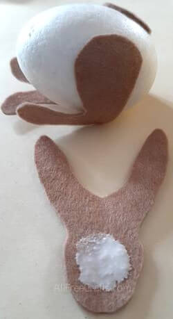 gluing felt bunny pieces onto a foam egg