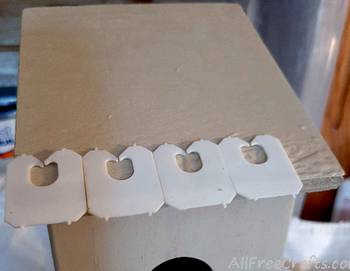 first row of bread tags on bird house roof